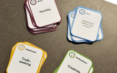 Four stacks of cards for learning Principled Innovation. One reads 'Humility', a second "Understand culture and context", a third "Truth-seeking", and a fourth "Creativity".